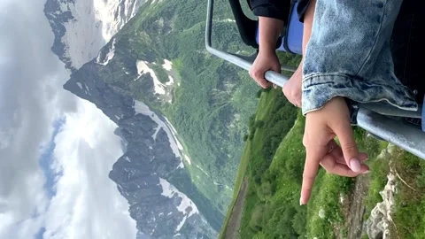 The hand points to the snow-capped mountains to the dombai lifts Video stock 208955058