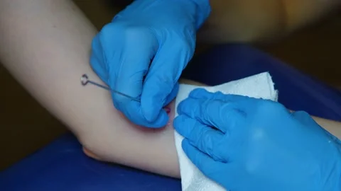 Hand poke tattoo close-up. Stuffing a tattoo with a needle. The process of Video stock 212428148