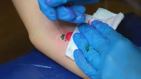 Hand poke tattoo close-up. Stuffing a tattoo with a needle. The process of Stock Footage 231496110