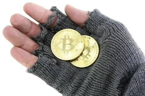 Hand of the poor with broken glove with two bitcoin coins 写真素材