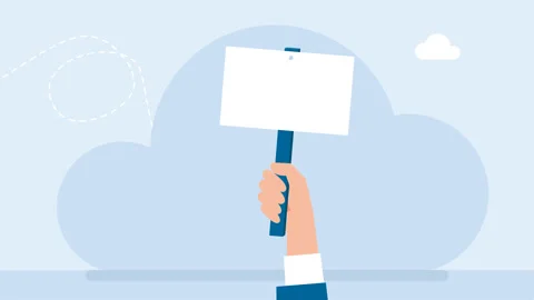 A hand with a poster appears from below. Man's hand holding a blank white poster Stock Footage 279936636