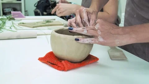 Hand potter making clay cup in pottery workshop studio Stock Footage