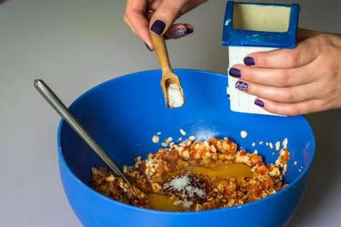 Hand pour in salt in stuffing Stock Photos