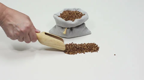 Hand pouring buckwheat Video stock 24760928