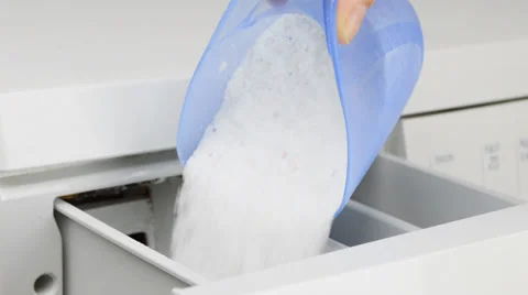 Hand pouring detergent into the washing machine Stock-Footage 37818377