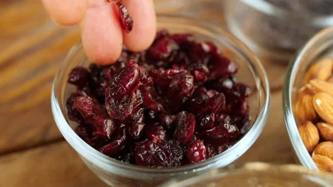 Hand Pouring Dried Cranberry into Small Bowl, HD Stock Footage 148189751