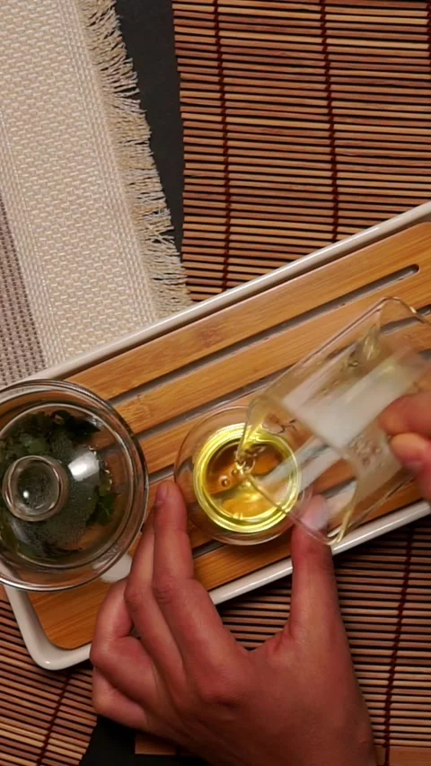 Hand Pouring Freshly Brewed Tea Glass Pitcher Top View Stock Footage 346774320