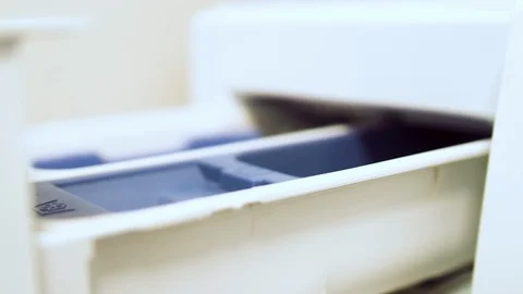 Hand pouring liquid detergent or softener into the washine machine dispenser Video stock 107984211