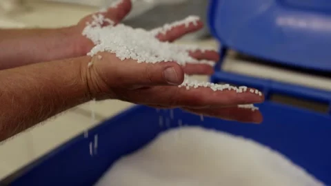Hand Pouring White Plastic Granules, Industrial Blue Container, Close Up Shot Vídeo Stock 341434562