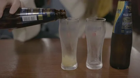 Hand pours beer in cup Stock Footage 222447589