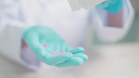 Hand pours one pill into your hand. Treatment with tablets, vitamins, dietary su Stock Footage 264105065