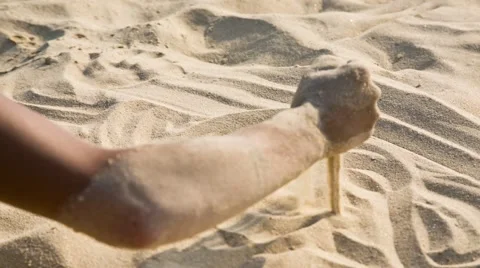 Hand pours sand on the beach Stock Footage 62294272