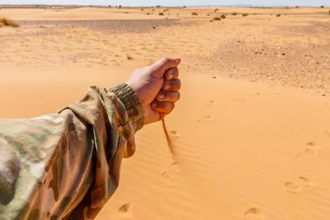 Hand pours sand Stock Photos