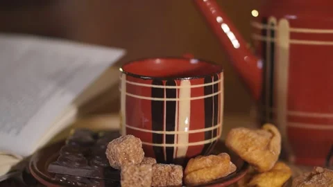 Hand pours tea from the teapot into a Cup Stock Footage 134887018