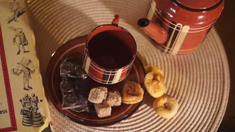 Hand pours tea from the teapot into a Cup Stock Footage 134887111