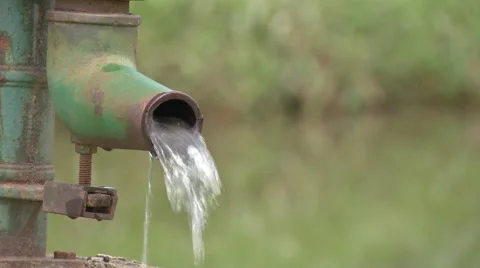 Hand-Powered Water Pump. Water from a hand pump Stock Footage 44021772