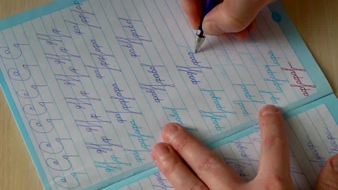 Hand is practice in handwriting in calligraphy notebook in slow motion Stock Footage 149963239