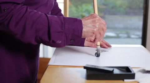 Hand Practicing Asian Calligraphy - Character for "Heart" - High View Stock Footage 45117455