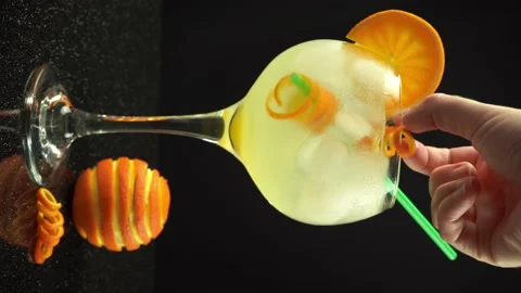 A hand preparing gin orange cocktail with ice, 4k vertical video, close up Stock Footage 159092733