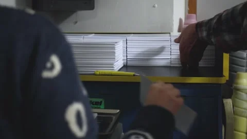 Hand preparing paper production, print shop. Work in progress, slow motion of Stock Footage 168183312