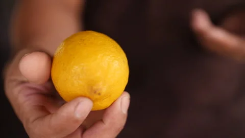 Hand Presenting Lemon, HD Stock Footage 148194590