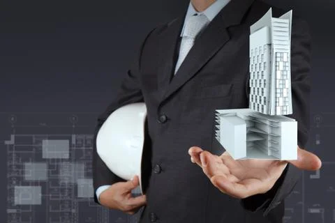 Hand presents building development as concept Ilustración de archivo