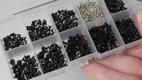 A hand presents a screw organizer for electronics, computer repair and precision Stock Footage 346875468