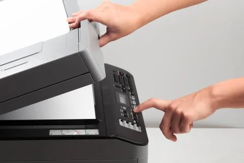 Hand press button on panel of printer. printer scanner laser office copy mach Foto stock