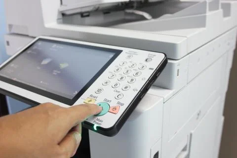 Hand press button on panel of printer Stock Photos