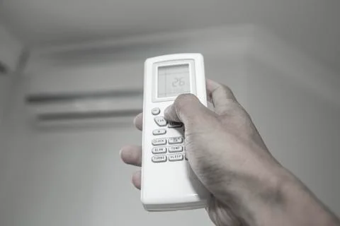 Hand press the button on the remote Stock Photos