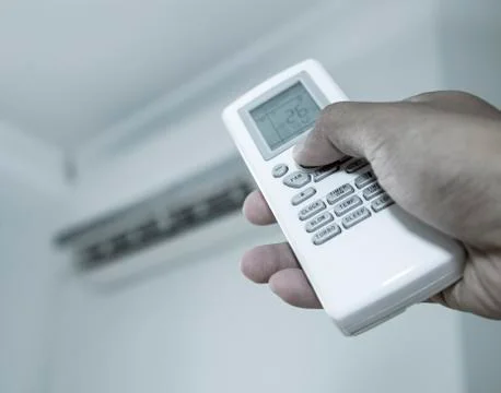 Hand press the button on the remote Stock Photos