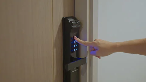 Hand press PIN number for smart digital door lock while open or close the d.. Stock Footage 329818507