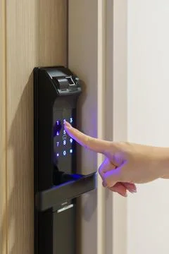 Hand press PIN number for smart digital door lock while open or close the d.. Stock Photos