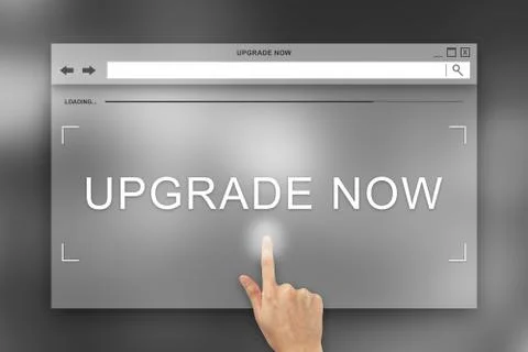 Hand press on upgrade now button on website Stock Photos