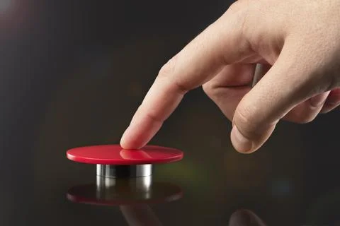 The hand presses the big red button. The concept of the threat of nuclear war. A Stock Photos