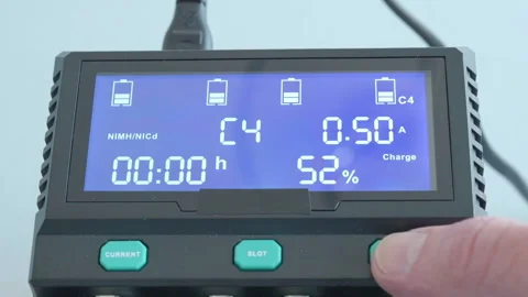 Hand presses button on digital battery tester Stock Footage 340531740