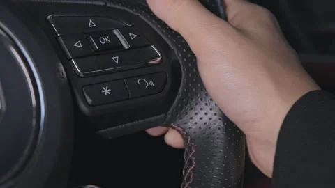 Hand presses a button to enable the voice command function on steering wheel. Stock Footage 181344959