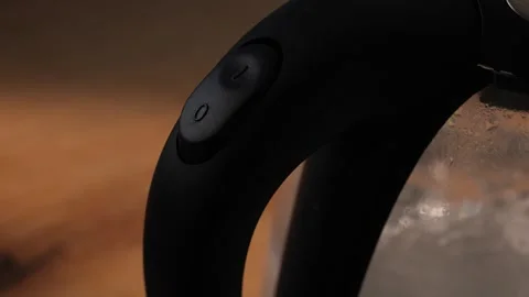 Hand presses button on kettle to start water boiling process Stock Footage 312278785