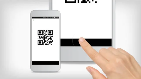 The hand presses the button of the smartphone, and scans the QR code Stock Footage 198563471