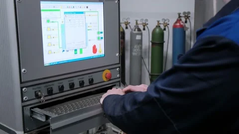 The hand presses the control buttons of the machine at the factory. The control Stock Footage 172014378