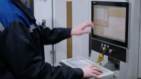 The hand presses the control buttons of the machine at the factory. The control Stock Footage 172014411