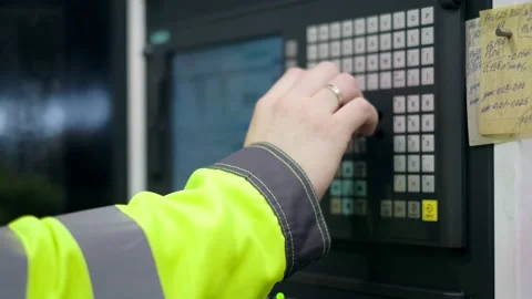The hand presses the control buttons of the machine at the factory. The control Stock Footage 172016848