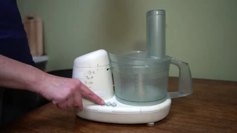 Hand presses different modes on a food processor Stock Footage 332227452
