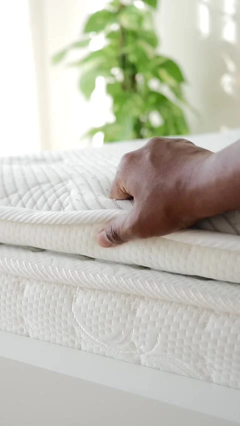 Hand presses down on soft mattress surface for comfort test. Stock Footage 332032244