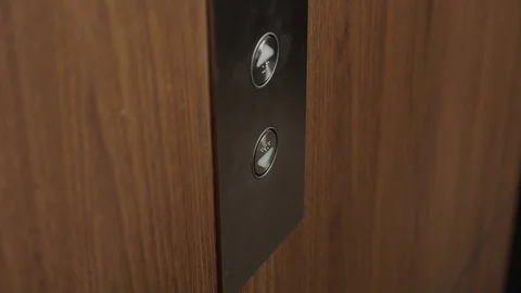 Hand presses elevator button to go down extreme close view Stock Footage 118444596