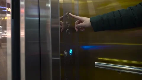 The hand presses the elevator button on the panel to go up. Call Stock Footage 153206519