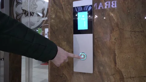 The hand presses the elevator button on the panel to go up. Call Stock Footage 153206619