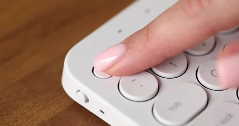 Hand presses esc button on white computer keyboard Stock Footage 246762544
