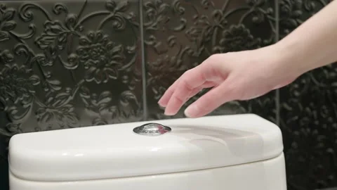 The hand presses the flush button on the toilet. Water saving. Video stock 171941892