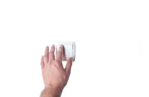 Hand presses a light switch isolated on white background Stockfoto's